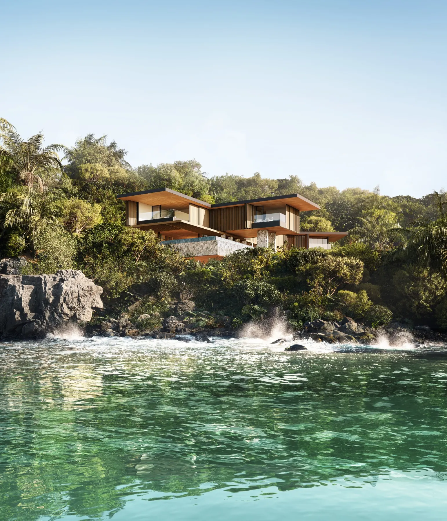 Contemporary coastal residence set into a lush rocky shoreline